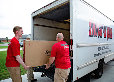 The Truck 'N Junk team loading items into the truck