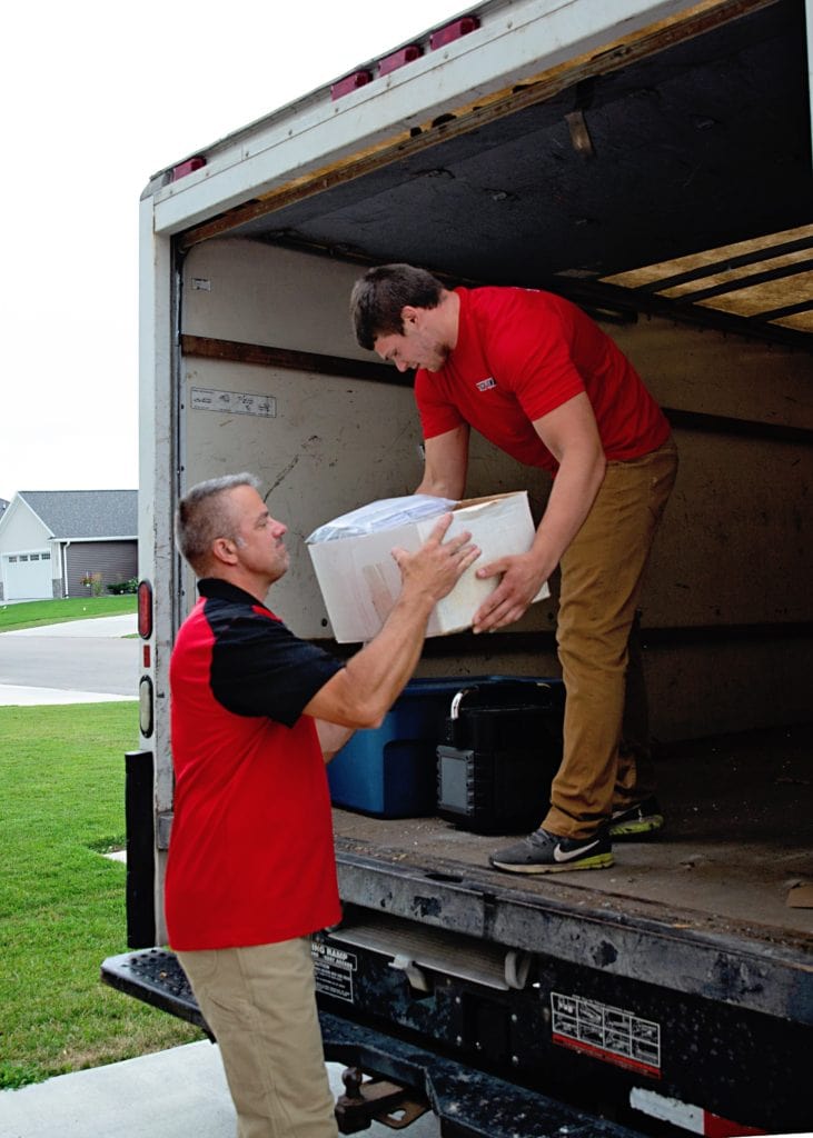 Contact Us Transferring junk removal items into the truck in Menasha